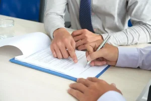 Man Double Checking Documentation for Accuracy